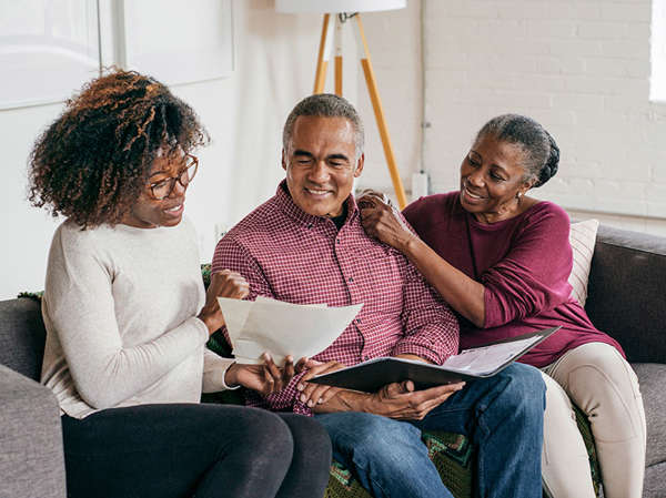 African American woman counsels elderly couple on how to create their will