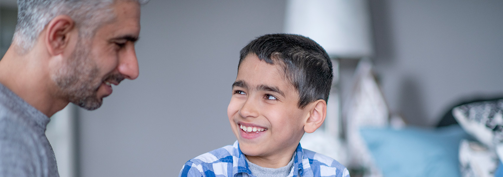 Afghan refugee boy listens to adult male mentor