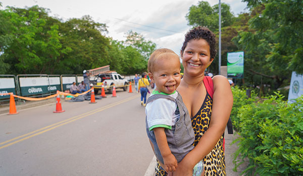 venezuelan mother holds her toddler son as they cross into safety in Colombia