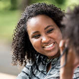 young african american adopted adult talks with a counselor about locating her international birth family