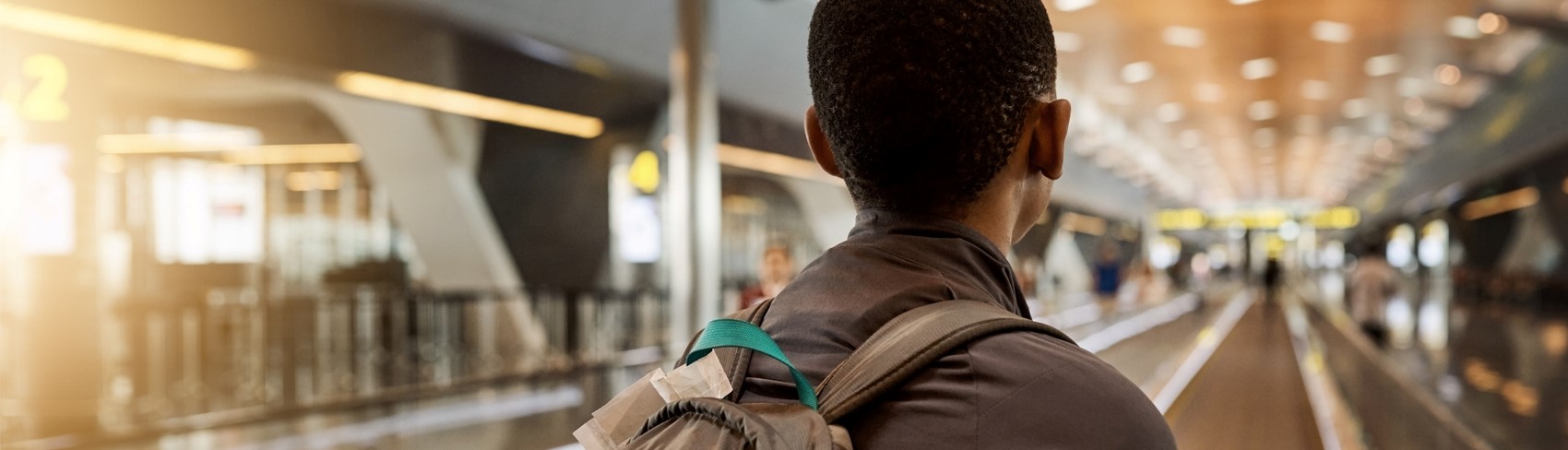 African refugee youth walking through an airport