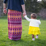 birth mother holds her daughter's hand during an open adoption visit