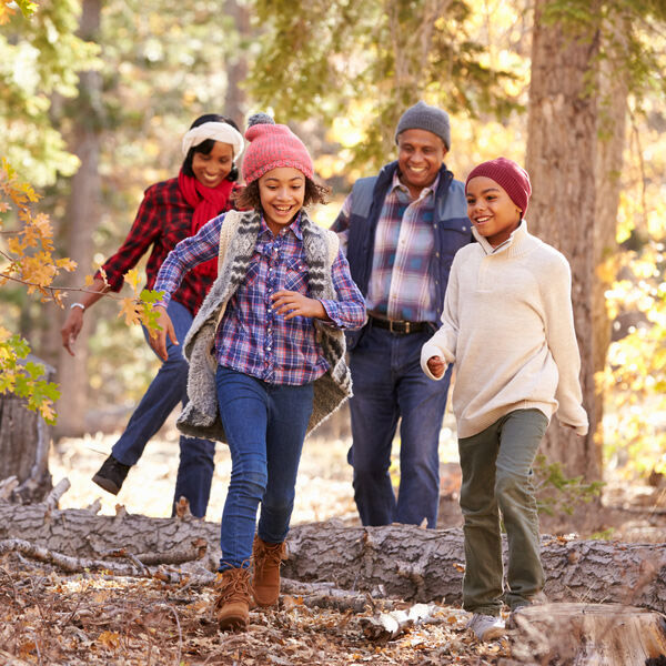 diverse family walks through the woods