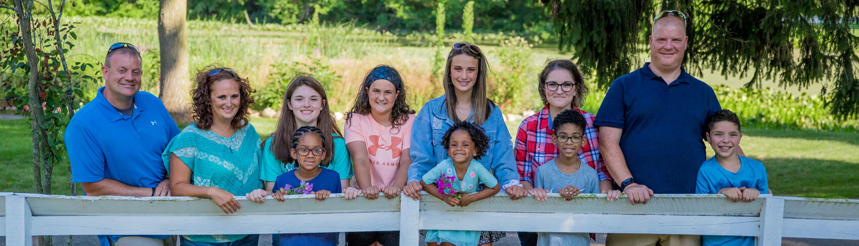 diverse foster kids climb on shoulders of older kids