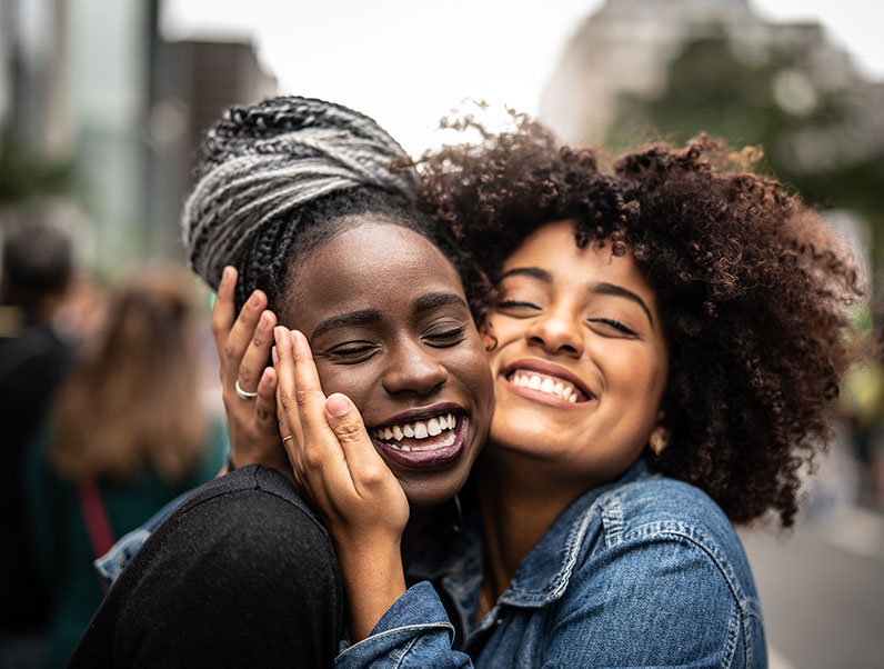 zambian young woman hugs her mentee