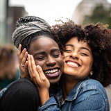 zambian young woman hugs her mentee